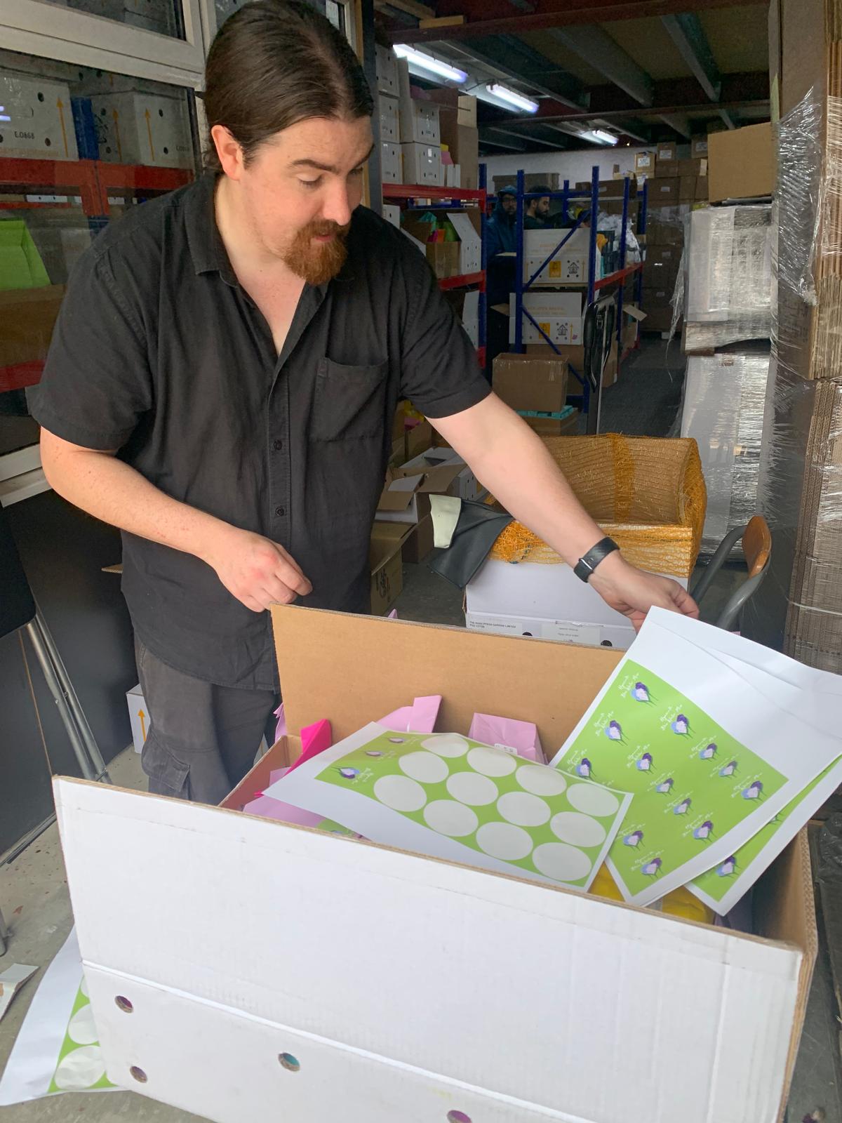 Welcome pack being assembled by hand at the OFEX warehouse